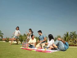 Family enjoying picnic in a park  Stock Footage