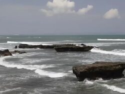 WS Rock formation and surf at echo beach, surfing beach, Batubelig, Asia AUDIO / Seminyak, Bali, Indonesia Stock Footage