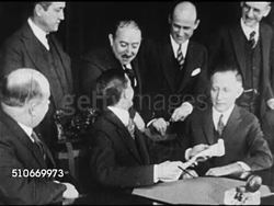 1922: CREATING INDUSTRY CENSORSHIP: WS Producers of the Motion Pictures Producers & Distributors Association standing together, lawyer Will H. Hays signing contract, Will shaking hands w/ producers. Instructional Video