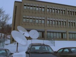 PAN MS View of satellite dishes 3-story office television station/ Pittsburgh, Pennsylvania, USA  Stock Footage