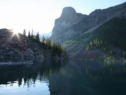 Sunrise view of birds fluttering above mountain lake Stock Footage
