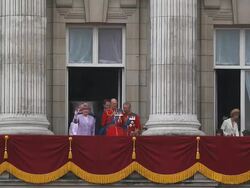 The Monarch Queen Elizabeth on her Official Birthday, comes out to greet the people , and the Royal Family come on to the Balcony at Buckingham Palace at the end of the ceremony of Trooping the Colour to view the flypast of the Royal Airforce jet aircraft Stock Footage