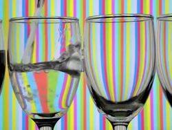 Light refraction pattern changes when filling drinking glasses with water. Stock Footage