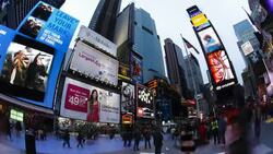 Pedestrians walk underneath large neon billboards in Times Square, New York. Stock Footage
