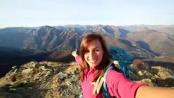 Young hiker takes selfie from mountain top Stock Footage
