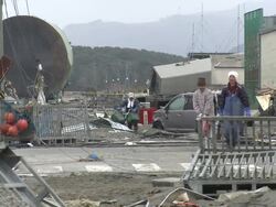 Destruction caused by tsunami after magnitude 9 Tohoku earthquake, north east Japan, March 2011. Men walk through wrecked streets of Ishinomaki City port, Miyagi Prefecture Stock Footage
