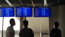 people looking schedule for flight airport Stock Footage