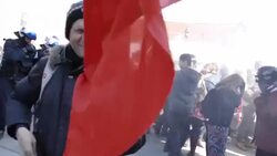 Riot police shooting pepper spray towards crowd of protesters Stock Footage