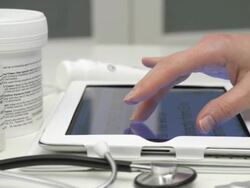 Dolly,L to R Female using tablet computer in clinic/pharmacy Stock Footage