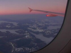 WS, New Zealand, Southern Alps seen through airplane window at dawn Stock Footage