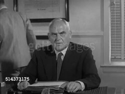 1952: CANADA: WS Parliament building (West Block, Parliament Hill), Minister of Trade & Commerce C.D. Howe (1886-1960) sitting at desk, aide w/ papers, SOT saying in midst of expanding naural resources & industrial potential, individuals production. Instructional Video