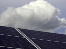 Solar Panels in Front of Cloudy Sky (Panning) Stock Footage