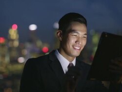 Young businessman working on a digital tablet at night. Stock Footage