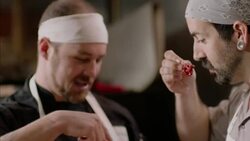 Restaurant chefs sample hot peppers, talk and laugh in kitchen restaurant Stock Footage