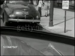 1949: ELIZABETHTOWN PARKING: DRAMATIZATION: WS Woman driving down street in convertible. (POV car) Turning into street parking space. CU Sign 'Don't Park Driveway.' WS Woman pulling away. (Car) into street parking spot. CU Hydrant. Instructional Video