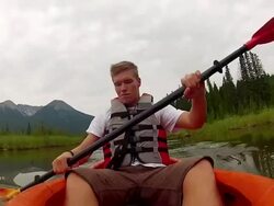 POV of person kayaking across mountain marshland Stock Footage