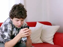 Pre-teen boy wins cell phone video game Stock Footage