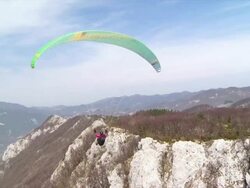 HD: Paraglider Soaring Over The Mountains Stock Footage
