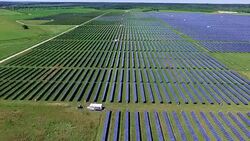 Forward Innovation Flying Over Solar Panel Farm Stock Footage