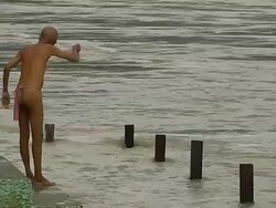 Block shot semi nude old man bathing in ganges haridwar uttarakhand Stock Footage
