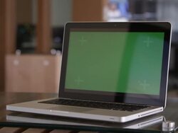 Panning shot of laptop with green screen on table. Stock Footage