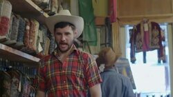 Two young men in cowboy hats have a fake shootout in Western store Stock Footage