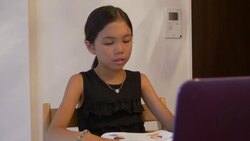 Japanese girl aged 9 years using laptop for online study English Stock Footage