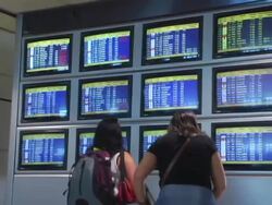 MS, Spain, Madrid, Two women looking at airport departure board, rear view Stock Footage