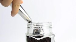 close-up panning: scoop coffee instant from a clear bottle Stock Footage