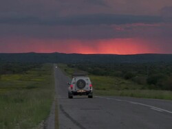 WS View of bitumen with hill at sunset / Namibia Stock Footage