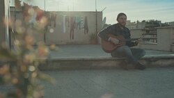 Hipster man playing acoustic guitar on the terrace Stock Footage