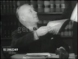 1937: WASHINGTON, D.C.: Embassy of Finland building. Minister Jarnefelt at desk, handing paper to aide. WS Main US Treasury building. Men working in large ledgers, male writing in ledger, CU Ledger page for Finland w/ payments filled in. Instructional Video