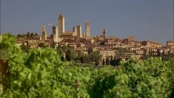 A walled medieval city sprawls on a hilltop in San Gimignano, Siena, Tuscany, Italy. Stock Footage