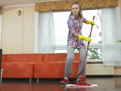 HD DOLLY: Cheerful Teenage Girl Mopping The Floor Stock Footage