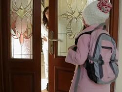 MS Schoolgirl knocking on door and hugging mother / China Stock Footage