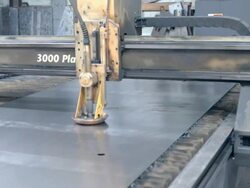 computer controlled cross beam moves plasma cutter torch across sheet metal to create precision cut outs / Redlands, California, USA Stock Footage