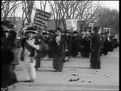 B/W 1910s crowd of women with signs marching in demonstration for suffrage on street Stock Footage