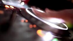 DJ's hand scratches and spins digital turntable Stock Footage