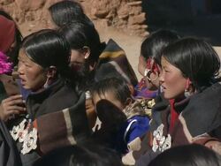 MS TD Saldang gompa tibetan buddhist monastery and assembled crowd at at Tibetan Buddhist  religious ceremony / Saldang village, High Himalayas, Upper Dolpo near Tibetan border, Nepal   Stock Footage