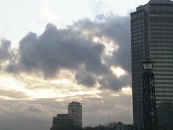 London traffic flows past skyscrapers on a cloudy day. Stock Footage
