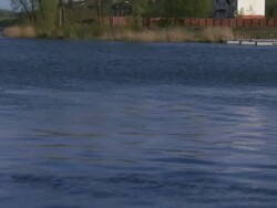 Zoom out from water to river boat moored at dock, Northern Ireland Stock Footage