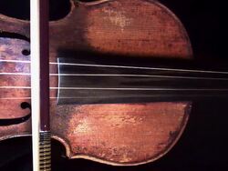 Close Up, Locked Down - A violin bow draws across the strings of a violin / USA Stock Footage