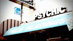 A sign and an awning advertise for a psychic. Stock Footage