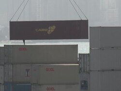Dock work dangerously guides container hanging from crane onto stack, Hong Kong Stock Footage