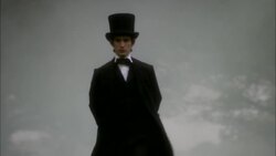 Young Abraham Lincoln wearing suit with Top hat and Bow Tie walking with hands behind back through foggy landscape Stock Footage