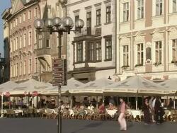 Medium tilt-up-Pedestrians pass through a marketplace in Prague. / Prague, Czech Republic Stock Footage