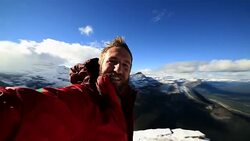 Hiker takes 360 degree view selfie on mountain top Stock Footage