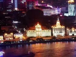 Time lapse wide shot high angle zoom out long shot Pudong Development Bank (formerly HSBC Building) on the Bund at night / Shanghai Stock Footage