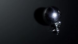 Small ball bearing rolling into a bigger one. Stock Footage