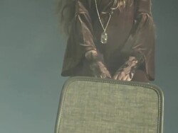 Rotating view of girl with suitcase, tilt up Stock Footage